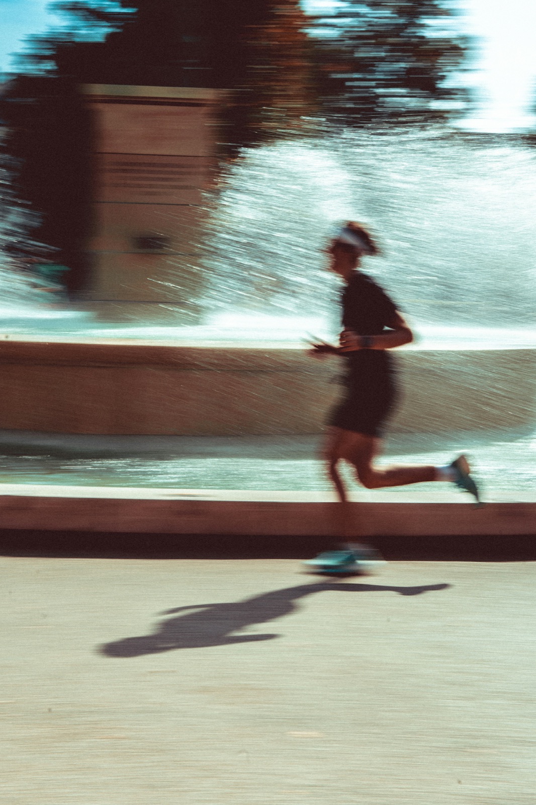 Runner speeding past a fountain